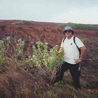 Charles Lindsey posing with crown flower