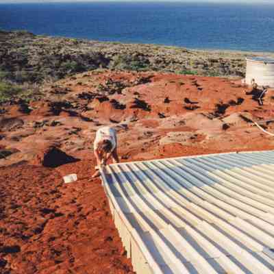 People working on water catchment and water tank