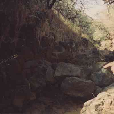 Man pointing to fallen rocks