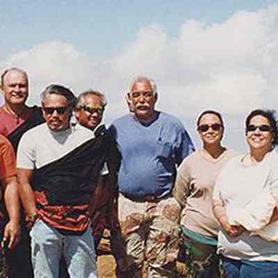 Group of people in front of rain ko'a (shrine)