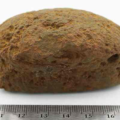 Profile of breadloaf sinker with ruler: The image shows the profile of a bread-loaf shaped rock on a white background with a ruler below it.