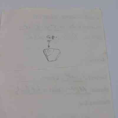 Back of artifact slip for KIRC Object ID #2015.006.146: The image shows a paper artifact slip with handwriting and a small sketched diagram, indicating descriptive details.