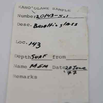 Artifact slip for a piece of basaltic glass: The image shows an artifact slip labeled "Kaho'olawe Sample," detailing basaltic glass with information with location, depth, and a date of June 20, 1977.