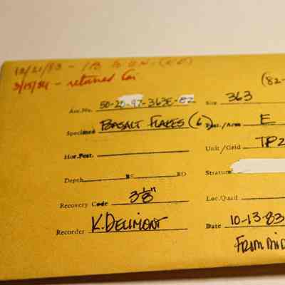 Manila artifact envelope for basalt flakes: The image shows a yellow envelope labeled for basalt flakes, includes specific details like accession number, site, depth, and date.
