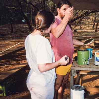 Two people working with paint