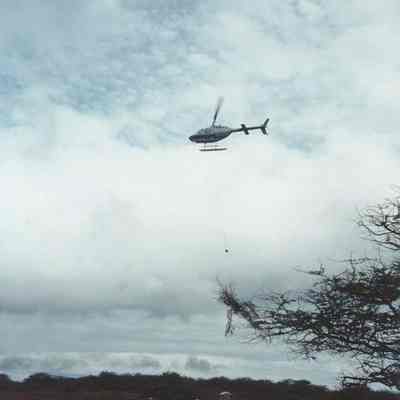 Helicopter hauling brush pile