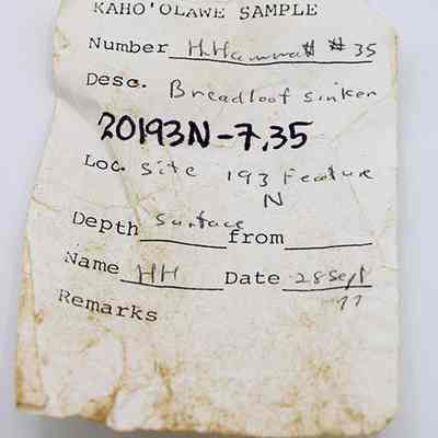 Artifact slip for a bread loaf sinker: The image shows a worn, handwritten label titled "Kaho'olawe Sample," detailing a breadloaf sinker.
