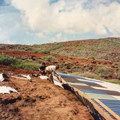 People working on water catchment structure