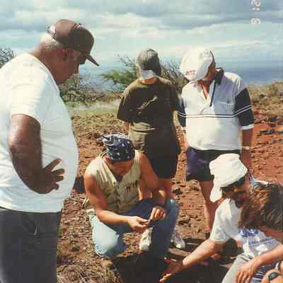 Several people examining arch site