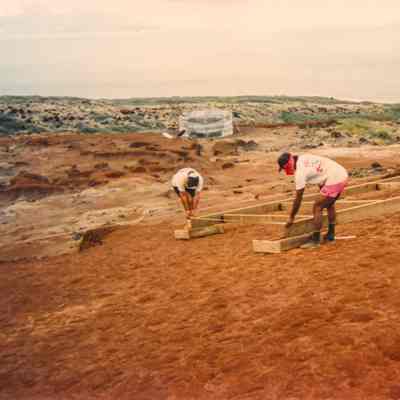 Two men constructing a wooden frame