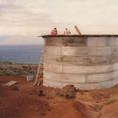 People working on top of water catchment