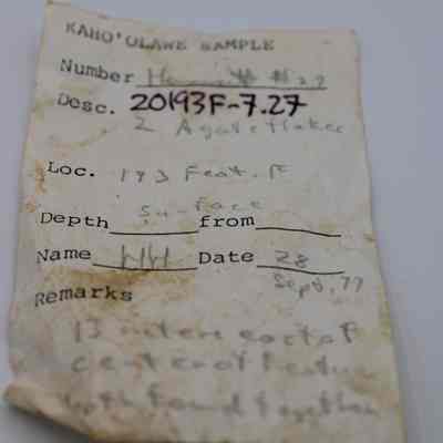 Artifact slip for two agate flakes: This image shows a weathered artifact slip from Kaho'olawe, detailing sample location, depth, and description of agate flakes.
