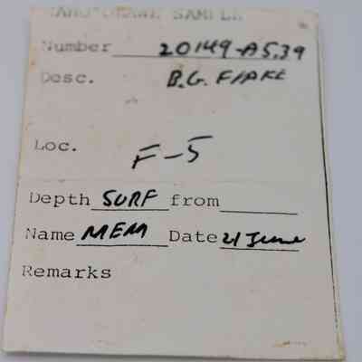 Artifact slip for basaltic glass flake: The artifact slip displays a record with number 20149 A539, labeled B.G. Flake, located at F-5, and dated 21 June.