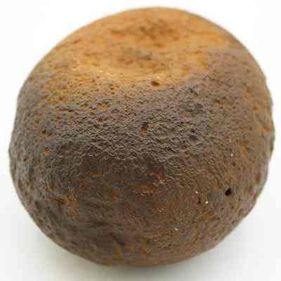 Hammerstone: The image displays a rugged, brown hammerstone , showing wear and rounded edges from repeated use as a tool.