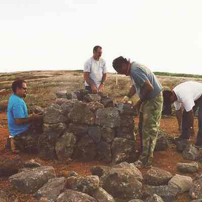 Four unidentified men building a koa