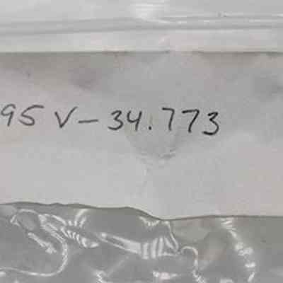 Bag label for hammerstone: The image displays a white rectangular label with handwritten numbers and letters "20 395 V -34.773," affixed to a clear plastic bag.
