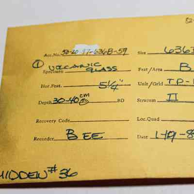 Artifact envelope for volcanic glass: The image shows a yellow data card detailing a specimen of volcanic glass. It includes details like site code "636B," depth "30-40 CM bs (below surface)."