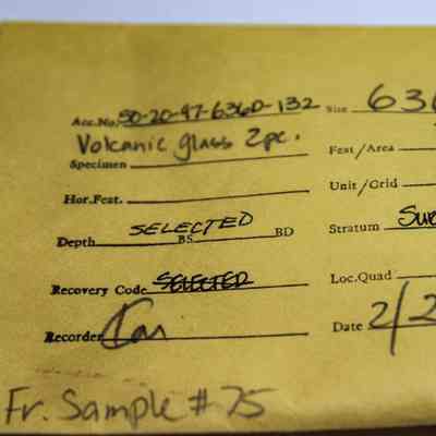 Artifact envelope for volcanic glass pieces: The image shows a labeled envelope containing volcanic glass specimen details, including accession number, site, date, and location grid. The specimen was recorded on 2/23/84.