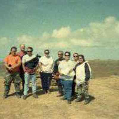 Group of people in front of rain ko'a (shrine)