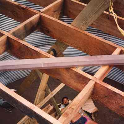 Man lying below wooden frame