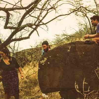 People discussing possible kiʻi pōhaku (petroglyphs)