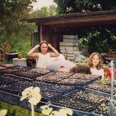 Girls next to seedlings