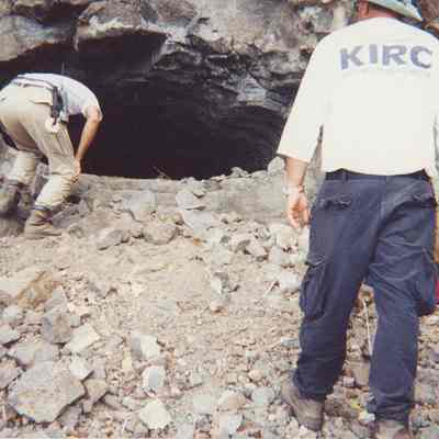 Two men examining potential arch site