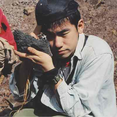 Unidentified man examining rock