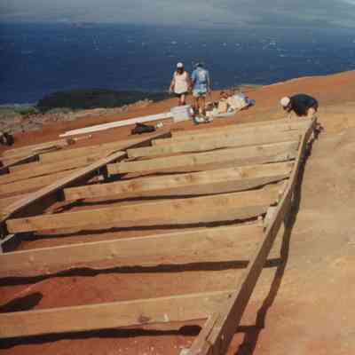 People working on wooden frame