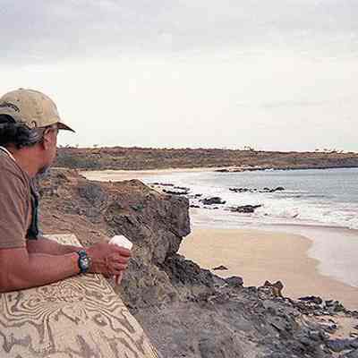 Unidentified man looking at an excavator