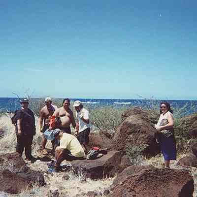 A group of people near pohaku (rocks)