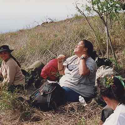 Three women sitting on ground