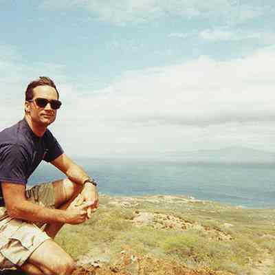 Unidentified man kneeling in unidentified area