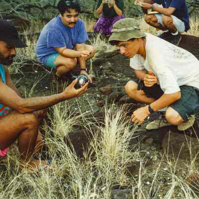 People examining object in a potential archaeological site