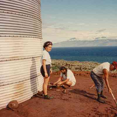 People working on and around water tank