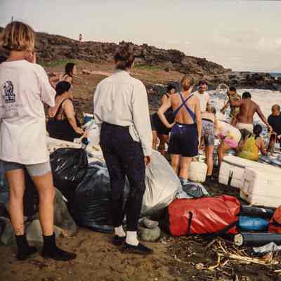 People unloading supplies on beach