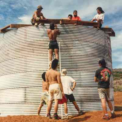 Group of men working a water catchment structure