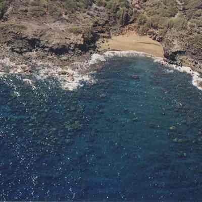 Aerial view of coral beds and rocky coastline