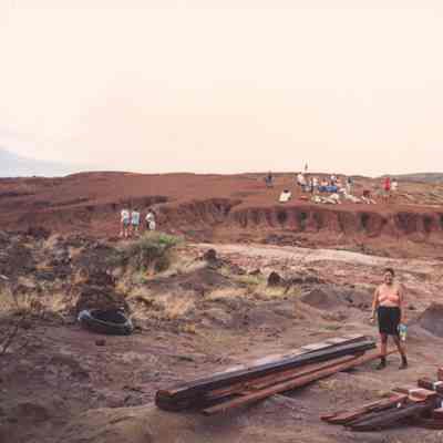 People around a construction site in hardpan terrain