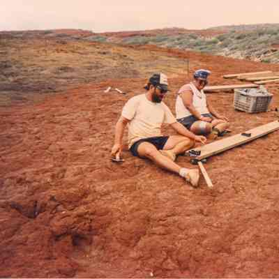 Two people working on wooden form