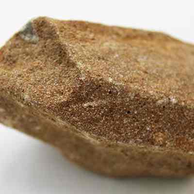 Profile of pumice file: The image shows a rough, brown pumice stone with a textured surface.
