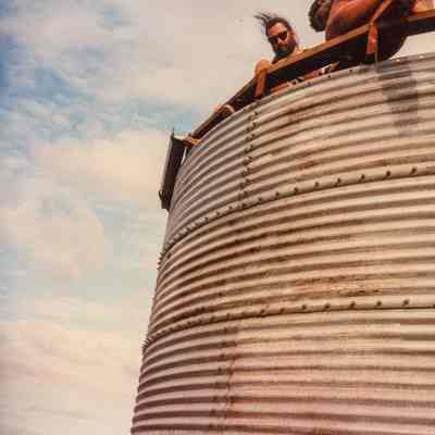 Corrugated water catchment with two men
