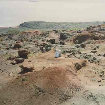 Hardpan terrain with white sign