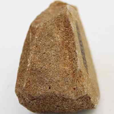 Lengthwise view of coral file: The image displays a close-up view of a natural pumice stone, showcasing its rough and porous texture.