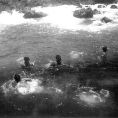 Cowboys bathing in ocean