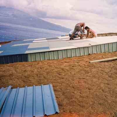 People working on top of a water catchment structure