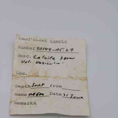 Artifact slip for calcite specimen: The image shows a labeled artifact slip describing a calcite sample, collected from a volcanic vesicle, with handwritten details.