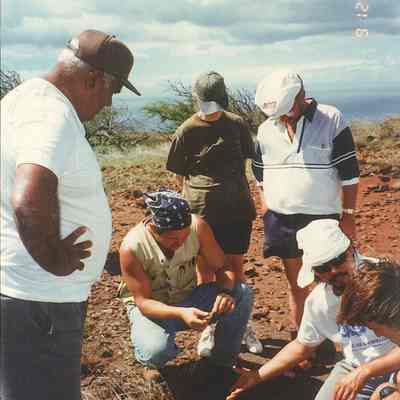 Several people examining an archaeological site