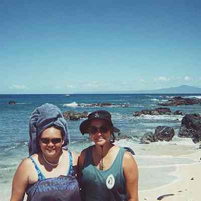 Two women on white sandy beach