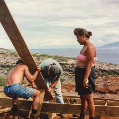 People working on wooden frame